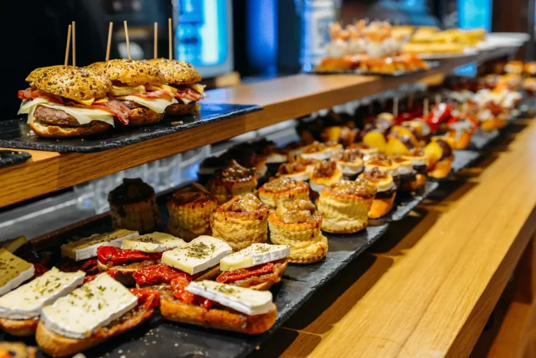 Tapas spagnole chiamate pintxos dei Paesi Baschi servite sul bancone di un bar in un ristorante di San Sebastian, Spagna